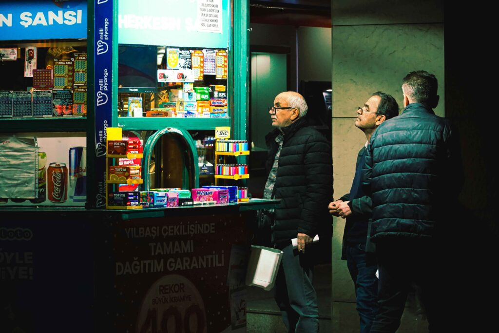 Men checking lottery ticket results